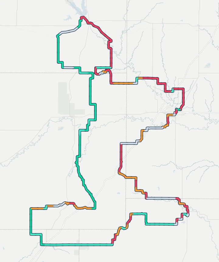 Map of the Unbound Gravel 200 route from Emporia south to Madison, west past Texaco Hill and Cassoday, north through Matfield Green to Council Grove and back east through Americus to Emporia, each stretch coloured by how often the wind was a headwind or a tailwind there in 10 years of race days.